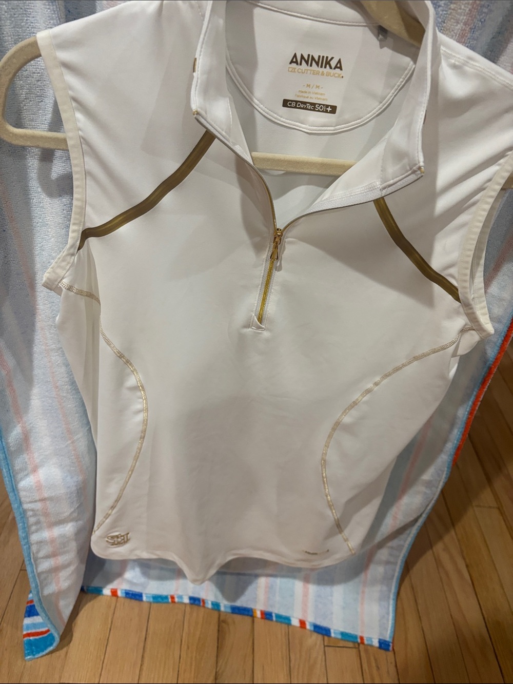 ANNIKA Women’s White Sleeveless Golf Polo with Gold Trim